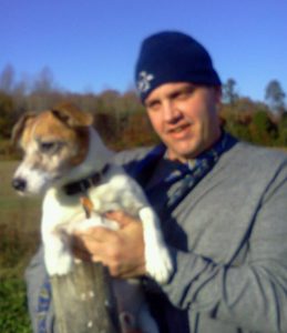 Photo of Brian Vaillancourt holding a terrier dog